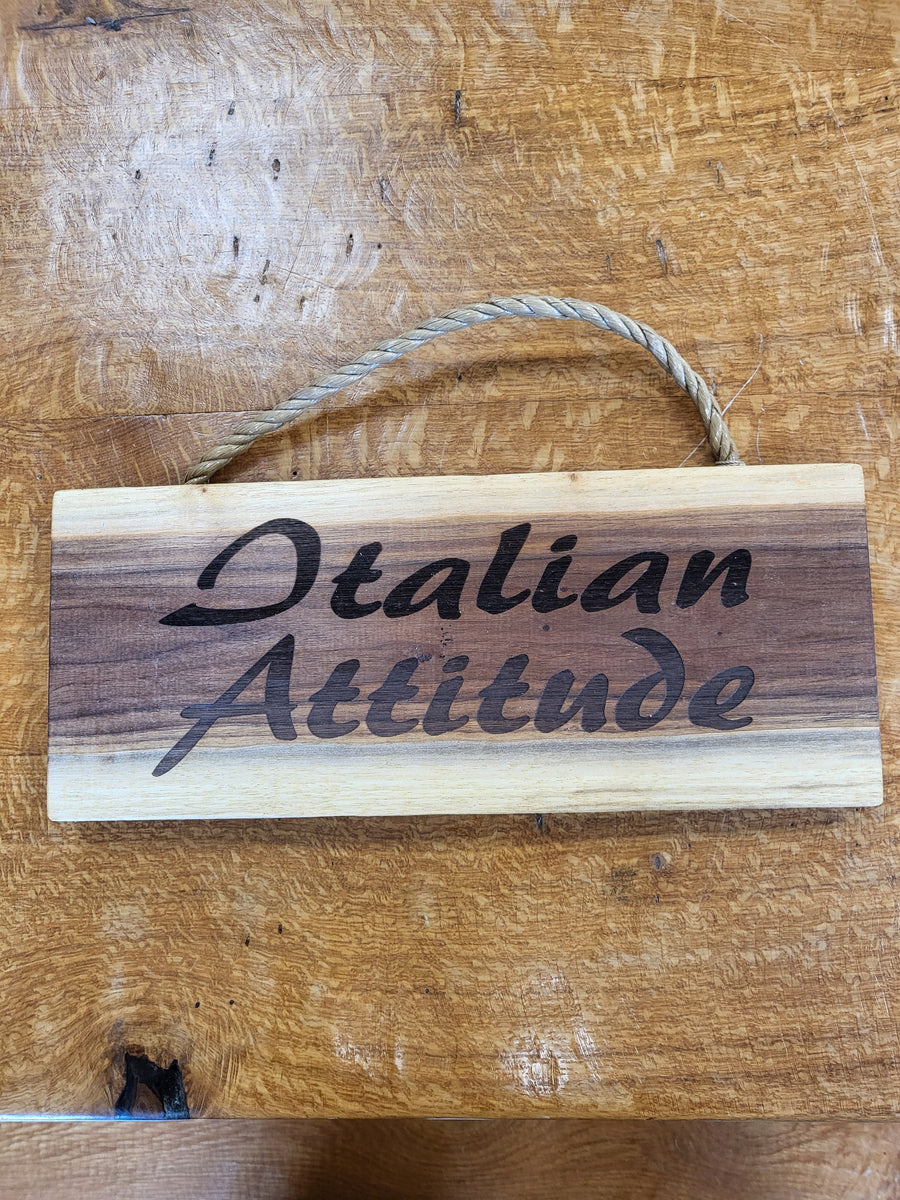 Wooden sign with 'Italian Attitude' text on a wooden surface