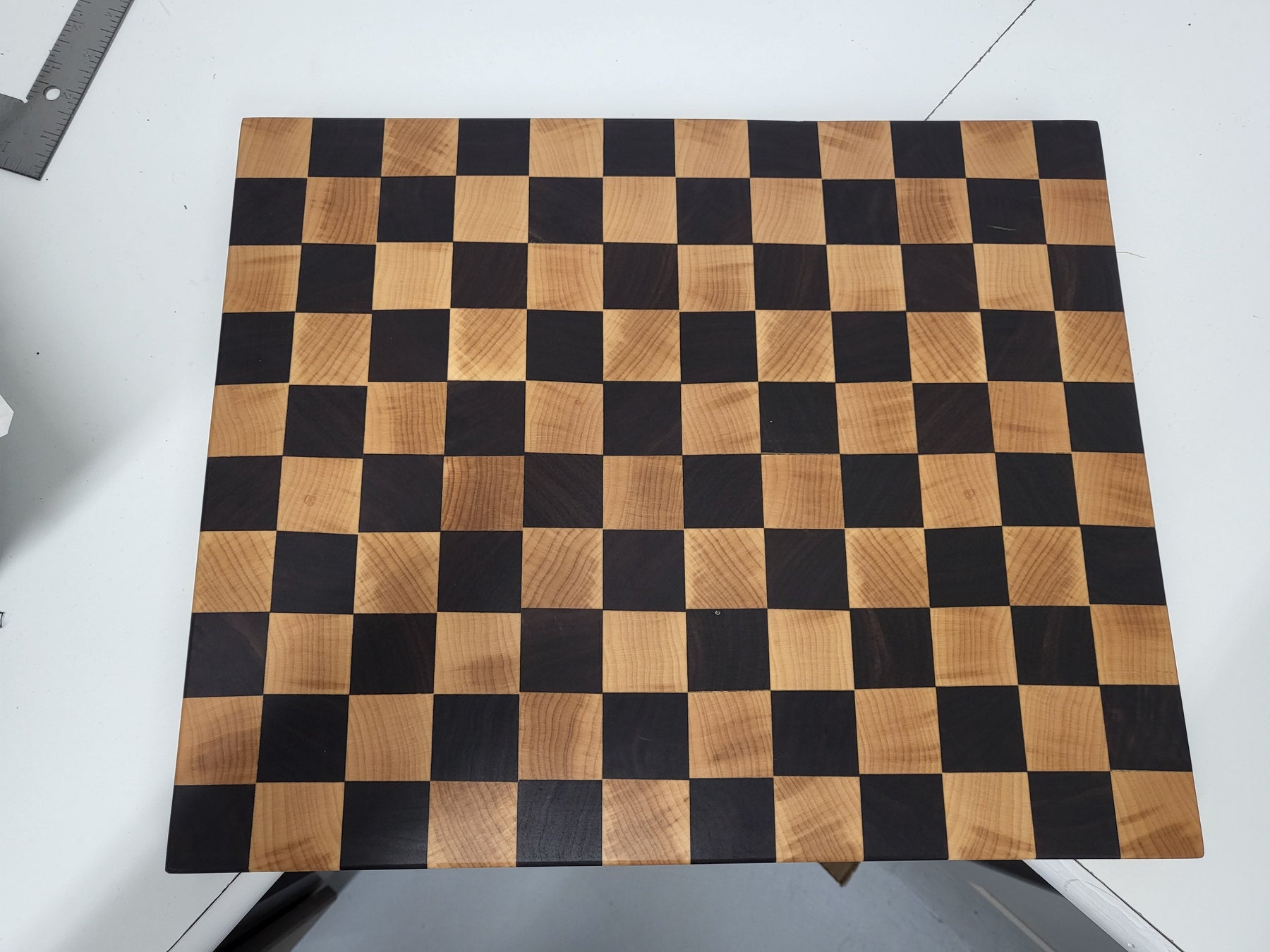 Wooden cutting board with checkerboard pattern