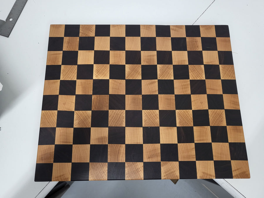 Wooden cutting board with checkerboard pattern